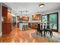 Bright, eat-in kitchen featuring stainless appliances, warm cabinetry, and hardwood floors at 4013 Hillendale Dr, Greenwood, IN 46142