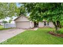 Charming single-story home with a brick facade, attached garage, storage building and well-maintained front yard at 4016 Dogwood Ln, Franklin, IN 46131