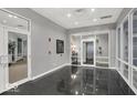 Elegant condo lobby with shiny black floors, glass doors, and modern design at 435 Virginia Ave # 108, Indianapolis, IN 46203