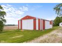 Large red barn on the property with white sliding doors at 4605 S 150 W, Columbus, IN 47201