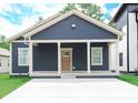 Inviting exterior view with blue siding, white trim, and a covered front porch at 4625 W Naomi St, Indianapolis, IN 46241