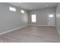Bright living room with hardwood floors, recessed lighting, and multiple windows at 4625 W Naomi St, Indianapolis, IN 46241