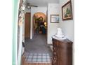 Inviting foyer with a decorative cabinet, soft carpet, and an arched entryway into the living area at 540 Cahill Ln, Indianapolis, IN 46214