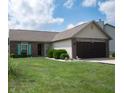 Lovely single-story home with a well-manicured lawn, brick accents, and a two-car attached garage at 540 Cahill Ln, Indianapolis, IN 46214