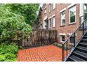 Brick patio area with mature trees providing shade, plus stairs to a second level entrance at 558 E Vermont St, Indianapolis, IN 46202