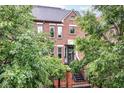 Elegant brick townhouse with landscaped front yard and gated entrance, perfect for privacy and curb appeal at 558 E Vermont St, Indianapolis, IN 46202