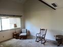 Cozy living room featuring a rocking chair, neutral carpet, and bright natural light at 5711 Bradston Way, Indianapolis, IN 46237