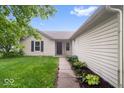 Charming single-story home featuring a well-kept lawn, and tasteful landscaping at 6011 Twyckenham Dr, Indianapolis, IN 46236
