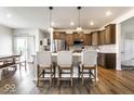 Open kitchen with breakfast bar, stainless steel appliances, and modern pendant lighting at 628 Tess Blvd, Westfield, IN 46074