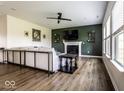 Cozy living room with fireplace, hardwood flooring, and large windows for natural light at 628 Tess Blvd, Westfield, IN 46074