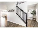 Bright foyer features a staircase with wooden floors and an elegant black banister at 628 Tess Blvd, Westfield, IN 46074