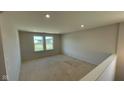 Spacious unfinished room with natural light streaming in from windows, perfect for a future living area at 6450 Stone Side Dr, Plainfield, IN 46168