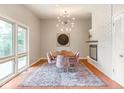Bright dining room featuring a modern chandelier, decorative fireplace, and large windows with natural light at 650 W Main St, Carmel, IN 46032
