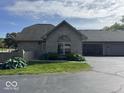 Charming brick home with lush landscaping and a two-car garage at 7548 Briarstone Dr, Indianapolis, IN 46227