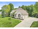 Charming two-story house with a well-manicured lawn, mature trees, and a spacious driveway leading to a two-car garage at 790 Foxboro Dr, Avon, IN 46123