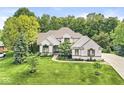 Beautifully landscaped two-story home with manicured lawn, mature trees, and brick facade at 790 Foxboro Dr, Avon, IN 46123