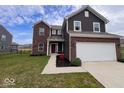 Charming brick and siding home with a two-car garage, complemented by landscaping in a front yard at 808 Capricorn Dr, Franklin, IN 46131