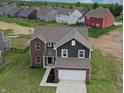 Beautiful home with a brick and siding exterior, well-manicured lawn, and a two-car garage at 808 Capricorn Dr, Franklin, IN 46131