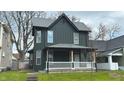 Charming two-story home featuring a welcoming front porch and classic architectural details at 909 N Temple Ave, Indianapolis, IN 46201