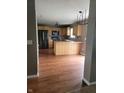 Spacious kitchen featuring modern appliances, wood cabinets, and an eat-in breakfast bar at 922 Eagle Brook Dr, Shelbyville, IN 46176