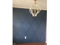 Wall with diamond trim and a decorative chandelier adds a touch of style to the space at 922 Eagle Brook Dr, Shelbyville, IN 46176
