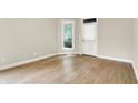 Bright and airy room featuring hardwood floors and natural light from the large window at 925 Fayette St, Indianapolis, IN 46202