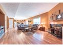 Open concept living room featuring hardwood floors, a fireplace, and a view to the kitchen at 977 Canary Creek Dr, Franklin, IN 46131