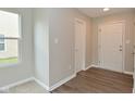 Bright foyer featuring hardwood flooring, with a window letting in natural light, and a closet for storage at 10431 Bellchime Ct, Indianapolis, IN 46235