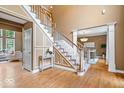 Inviting foyer with hardwood floors, staircase, and elegant architectural details at 11227 Woods Bay Ln, Indianapolis, IN 46236