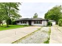 Cozy single-story home with a long, cracked driveway and a detached garage, ready for new memories at 11309 N County Road 750 W, Elwood, IN 46036