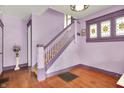 Elegant entryway featuring hardwood floors, a staircase, and stained glass windows, creating a welcoming ambiance at 1138 N Oxford St, Indianapolis, IN 46201