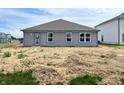 The backyard has a charming gray single-story house with neatly placed windows and a door for easy access at 1170 Mcbride St, Greenfield, IN 46140