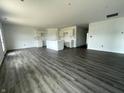 Spacious open-concept featuring gray hardwood floors and unfinished white cabinets, awaiting personalization at 1170 Mcbride St, Greenfield, IN 46140