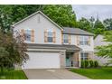 Two-story home featuring a light siding, wooden shutters, and manicured lawn at 11919 Gatwick View Dr, Fishers, IN 46037