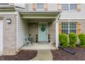 Charming front porch with a blue door, chairs, and decorative plants at 11919 Gatwick View Dr, Fishers, IN 46037