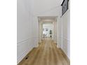Elegant hallway featuring hardwood floors, decorative molding, and column accents at 11984 Talnuck Cir, Fishers, IN 46037