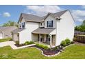 Side view of a two-story home with white siding and a manicured lawn at 1222 Grand Canyon Ct, Franklin, IN 46131