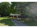 Beautiful two-story home with brick accents, mature trees, and a long driveway on a lush green lawn at 1238 N 650 W, Anderson, IN 46011
