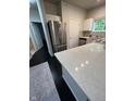 Bright kitchen with marble countertops, stainless steel appliances, and dark hardwood flooring at 12853 Tradd St # 2B, Carmel, IN 46032