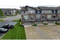 Contemporary townhome featuring private garages, balconies, and well-maintained landscaping at 12908 Grand Blvd, Carmel, IN 46032