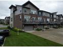 Rear view of modern townhomes, highlighting private garages and balcony spaces at 12908 Grand Blvd, Carmel, IN 46032