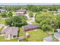 Aerial view of the home showcasing its well-maintained lawn, proximity to community features and mature trees at 1308 N Main St, Lapel, IN 46051