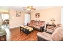 Cozy living room with hardwood floors, comfortable seating, ceiling fan and an abundance of natural light at 1308 N Main St, Lapel, IN 46051