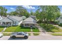 Street-level view featuring charming single-story home surrounded by mature trees and greenery at 145 S 7Th Ave, Beech Grove, IN 46107