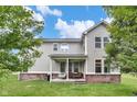 Back of home featuring a cozy covered patio with porch swing, an outdoor grill, and seating at 14931 W Black Wolf Run Dr, Carmel, IN 46033
