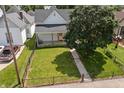 Aerial view of the home showing the yard, nearby trees, fence and landscaping at 1627 Pleasant St, Indianapolis, IN 46203