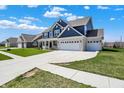 Eye-catching home boasting a three-car garage, lush lawn, and an extended driveway for ample parking at 1704 Beach St, Greenwood, IN 46143