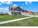 Landscaped home with green grass, and a spacious driveway, perfect for enjoying suburban living at 1704 Beach St, Greenwood, IN 46143