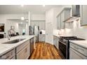 Modern kitchen boasts stainless steel appliances, sleek countertops, and stylish wooden flooring at 19257 Red Willow Ln, Noblesville, IN 46062