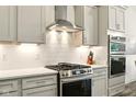 Well-equipped kitchen featuring stainless steel range, subway tile backsplash, and ample storage space at 19257 Red Willow Ln, Noblesville, IN 46062